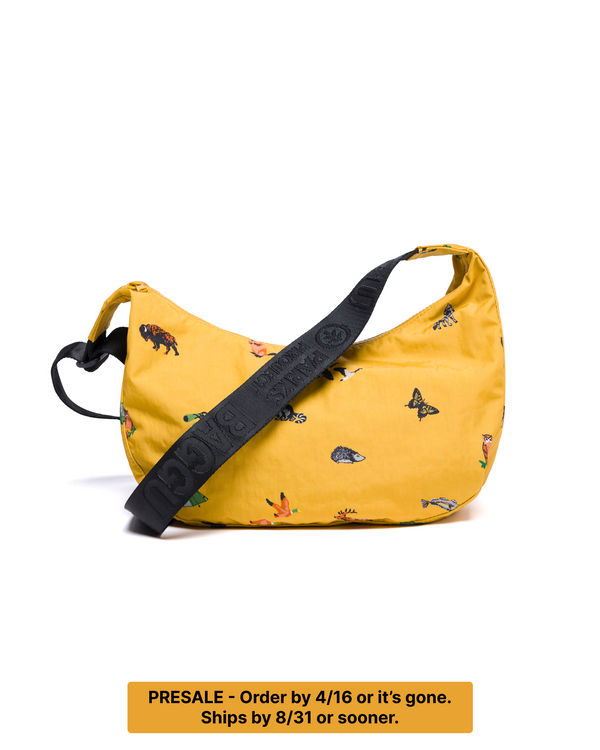 PRESALE-ORDER BY 4/16. SHIPS BY 8/31 OR SOONER. Shop Naturalist Club BAGGU Medium Nylon Crescent Bag Inspired by National Parks | mustard