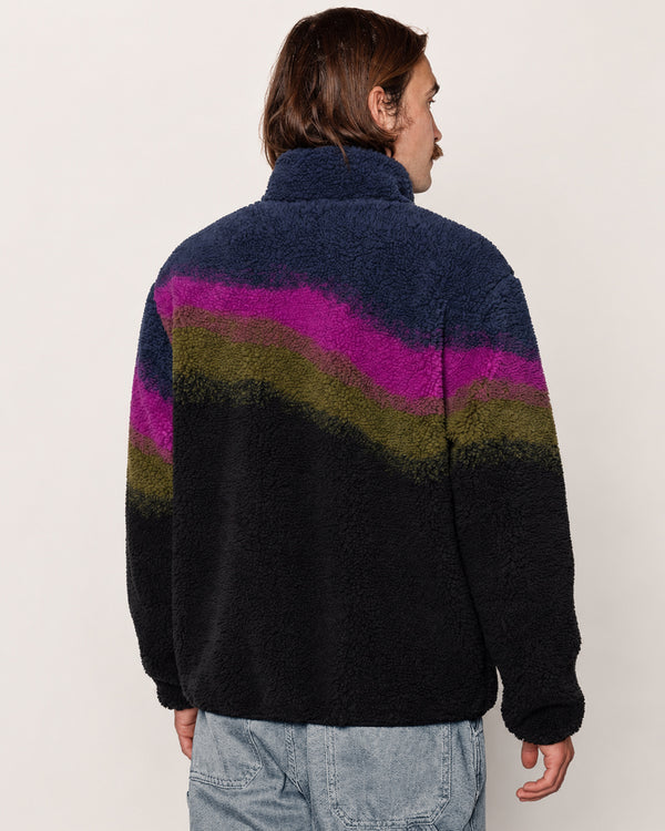 A man wearing a dark navy high pile fleece pullover with a wavy stripe pattern in magenta, olive green, and black, shown from the back against a plain off-white background.

Shop Borealis High Pile Fleece Jacket Inspired by Alaskan Parks | multi-color